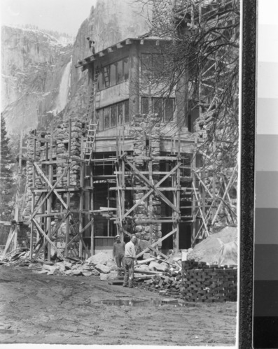 View showing Yosemite Falls and the Ahwahnee under construction.