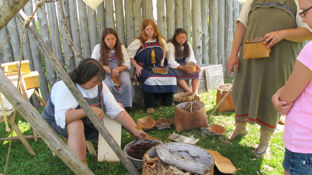 Reenactors making birch bark baskets.