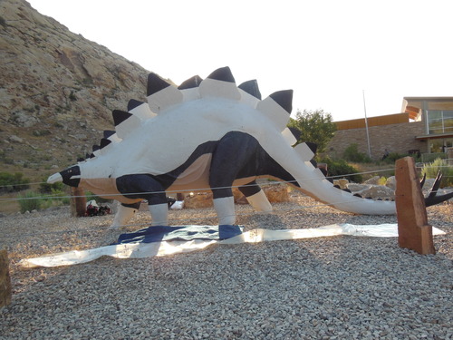 Black and white dinosaur statue on grey rocks