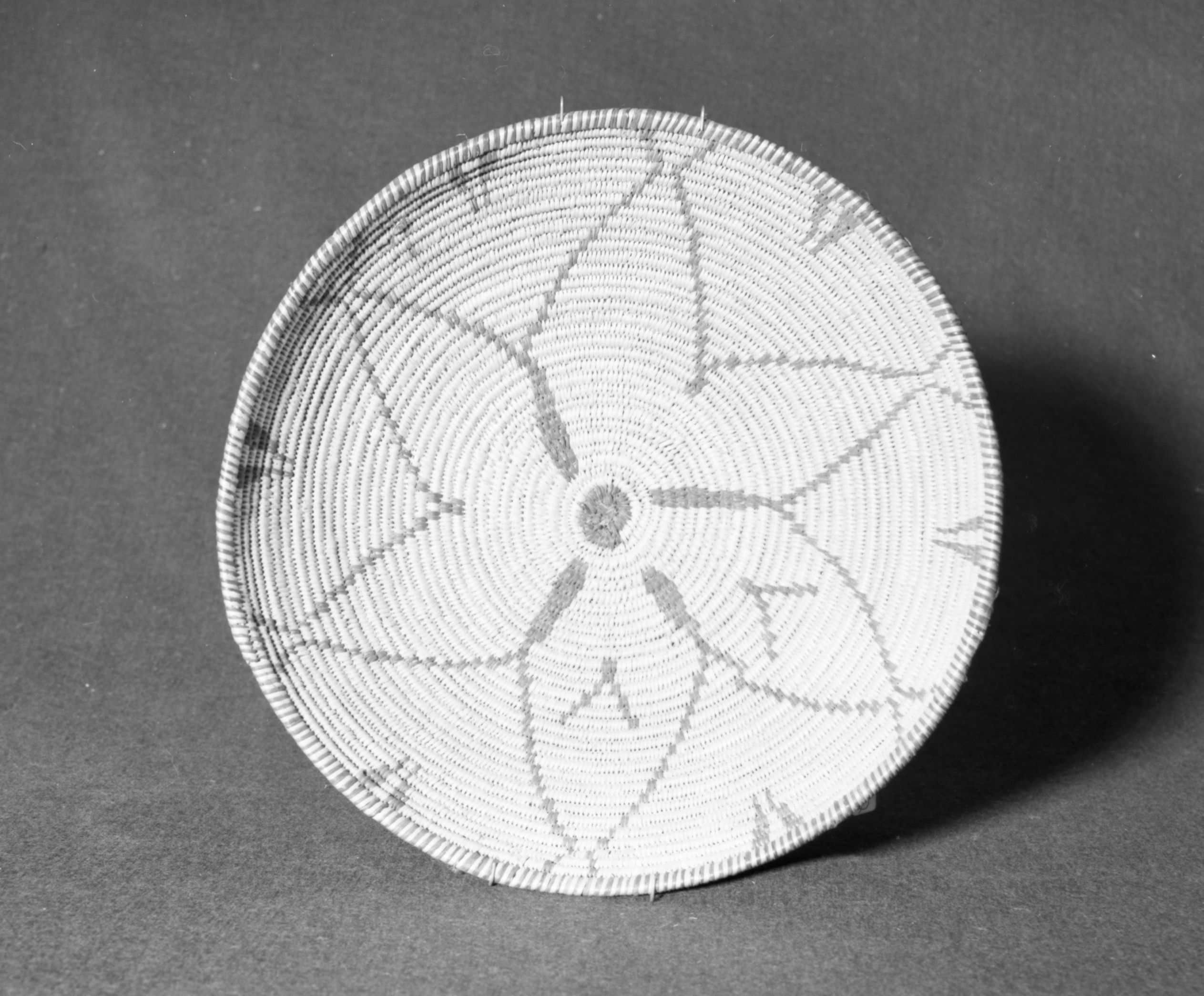 Marie Rozier Collection, Catalog No. 112. Object: Western Apache (?) basket. Dimensions: 3 x 12 1/2". Materials: willow, devil's cloth. Technology: three rod foundation, leftward coil direction, non-interlocking stitching. Collection History: Alice Reade Collection. Photographed by Michael Dixon, December 1982. Catalogued by Craig Bates and Barbara Beroza. Yosemite Collections, National Park Service.