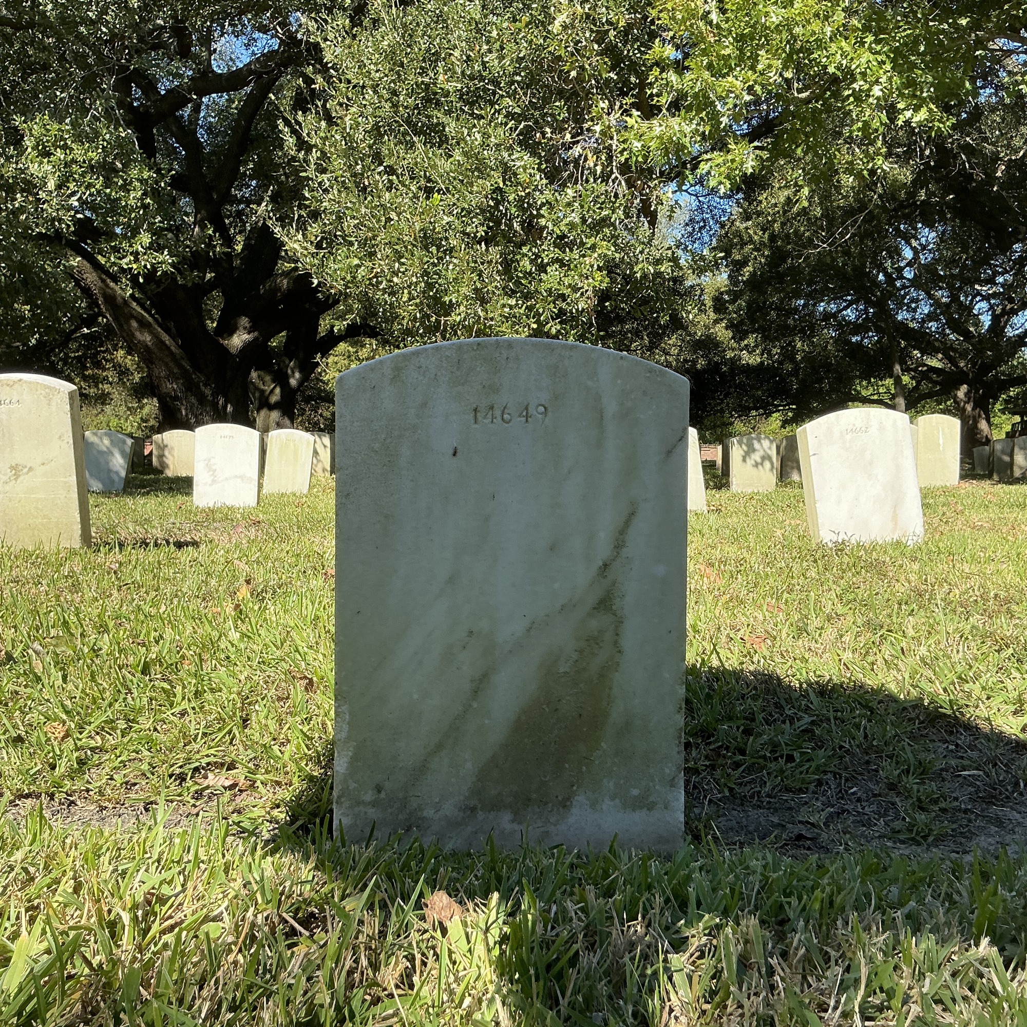 Back of upright marble headstone with flat face.