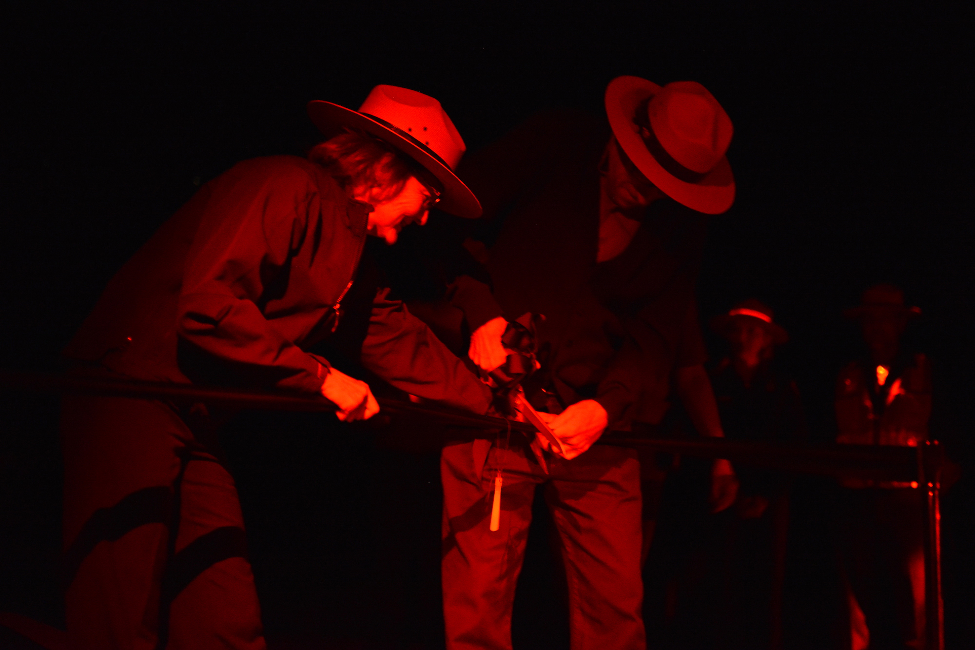 two rangers illuminated in red cut a ribbon