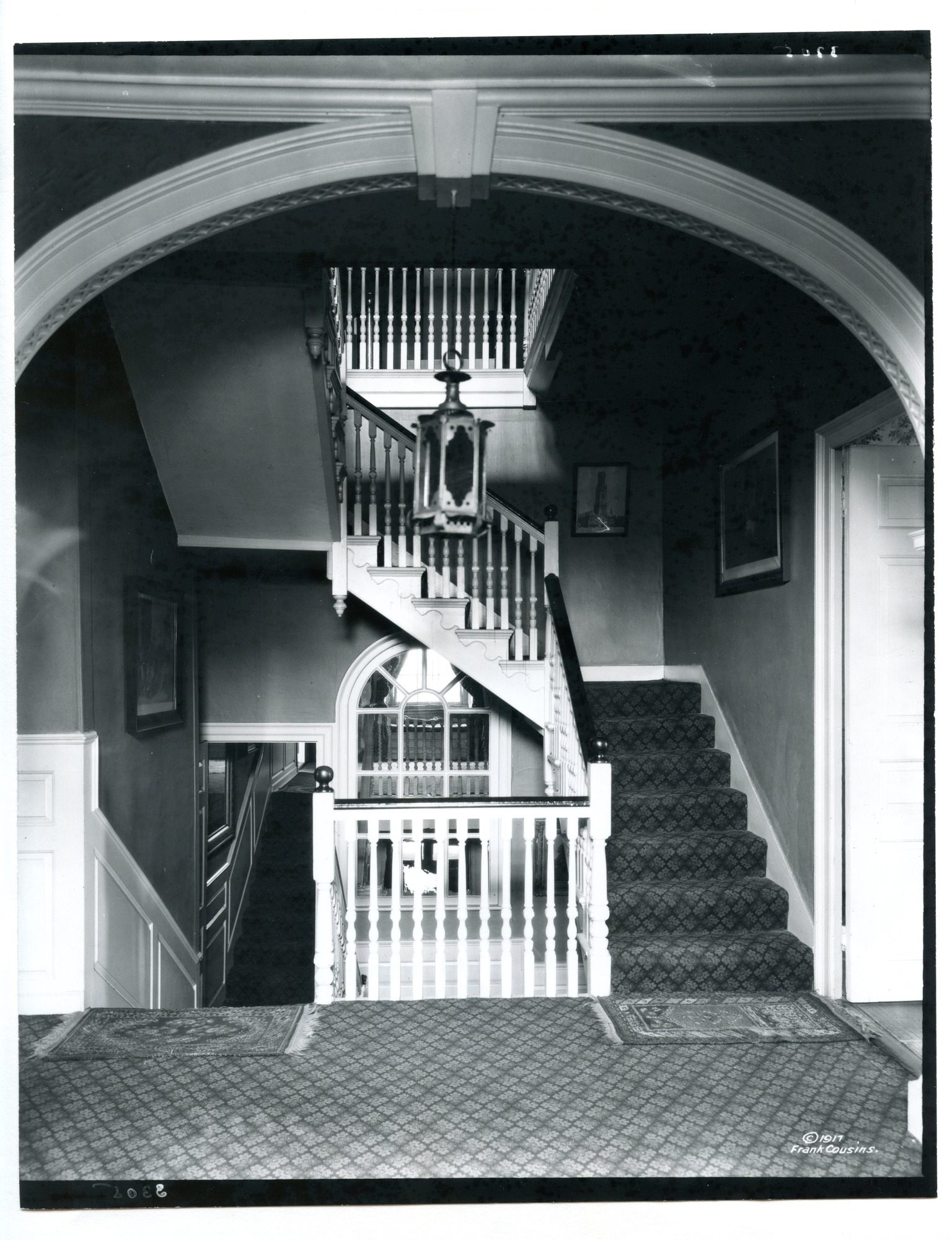 Black and white photograph of arch and staircase.