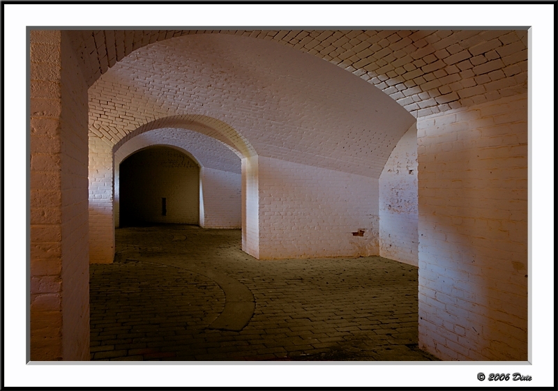 Afternoon sun shines through the embrasure openings on the white washed walls inside Fort Barrancas.