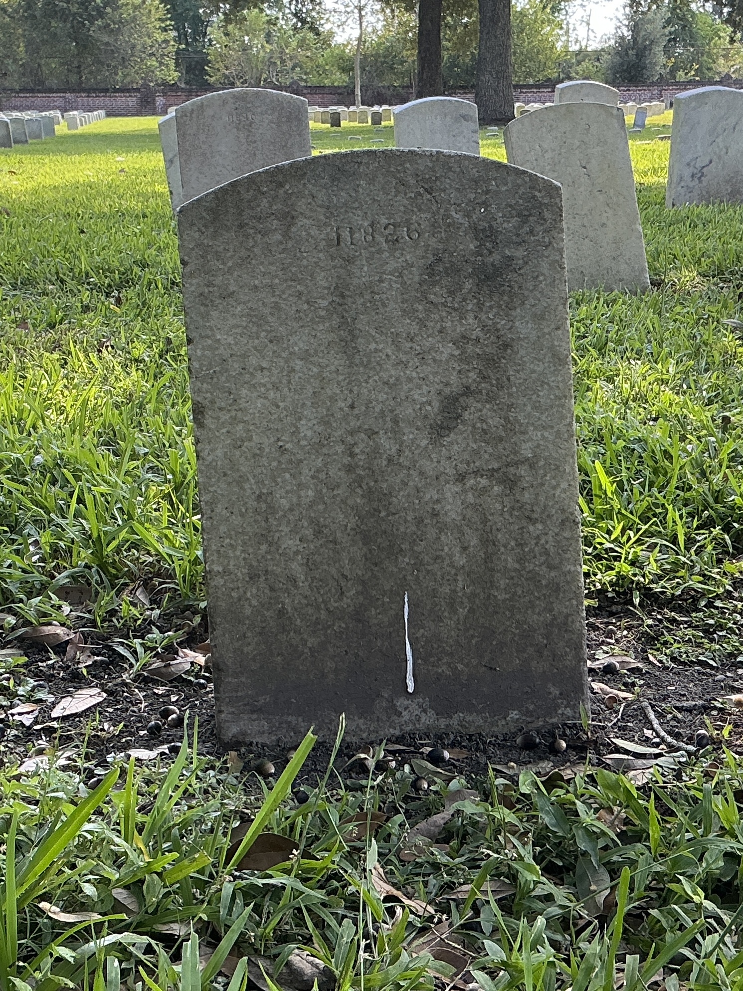 Back of upright marble headstone with flat face.
