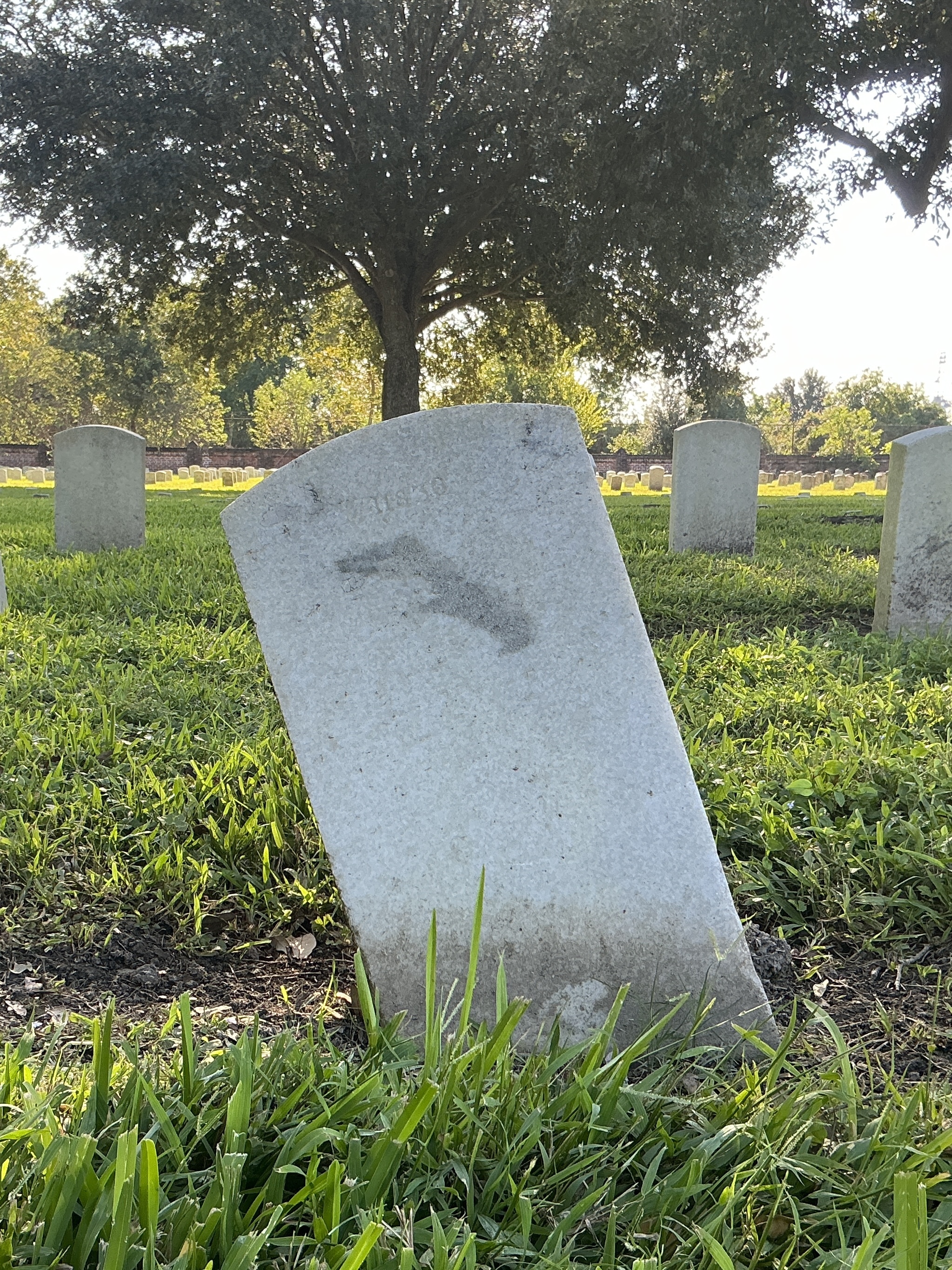 Back of upright marble headstone with flat face.