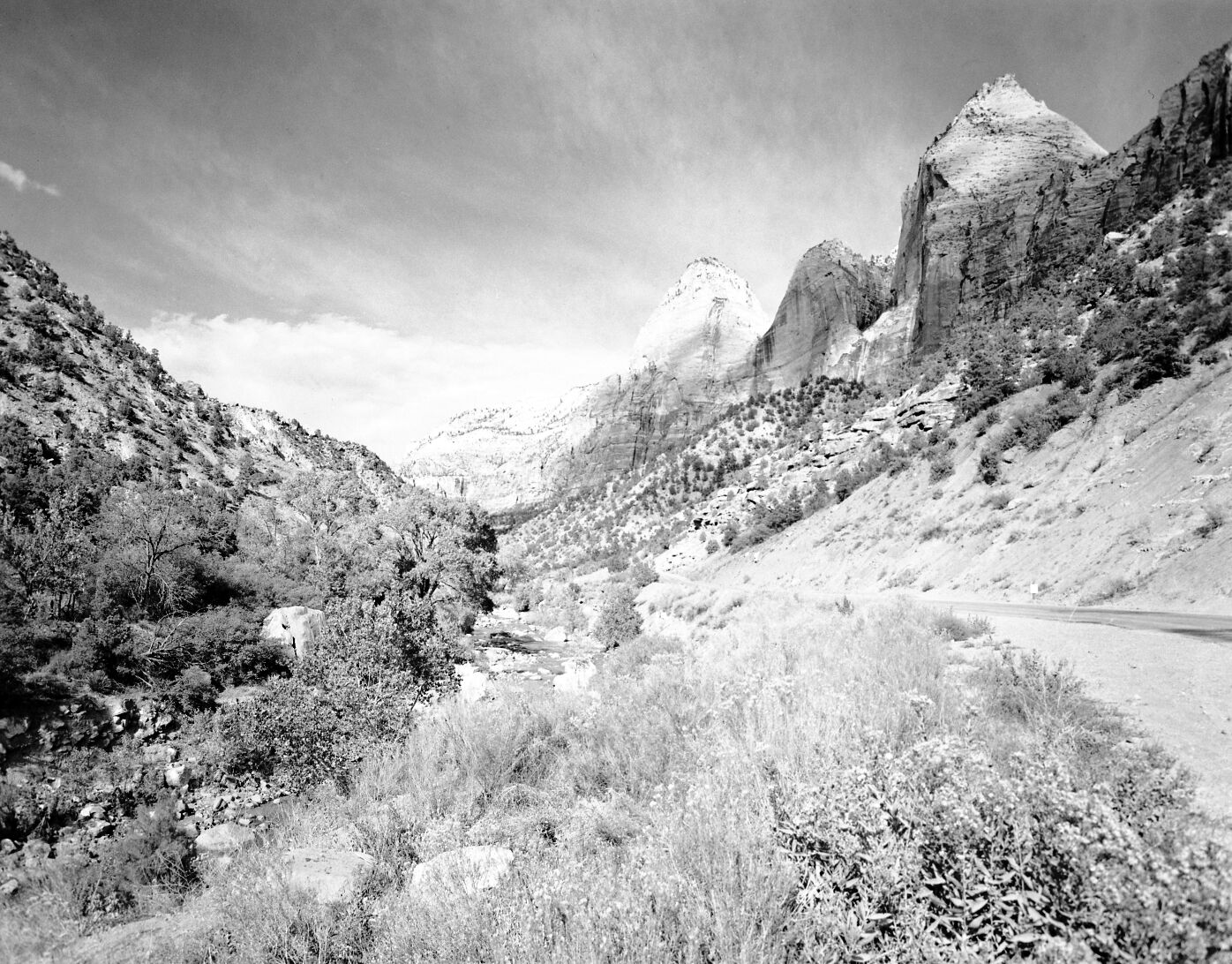 The Twin Brothers and Mountain of the Sun (east wall of Zion Canyon) with Zion Canyon road on right side.