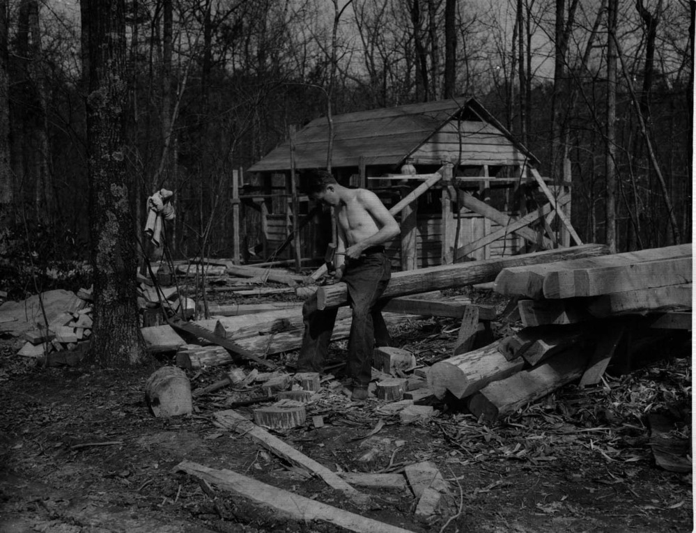 Young boys of the CCC at work in front of a cabin