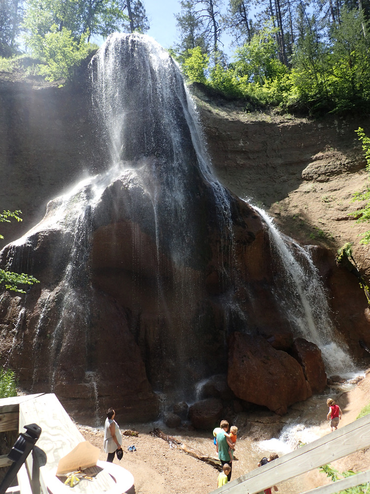 People wade in the pools at the bottom of Smith Falls
