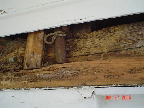Shows disintegrated sill beam in kitchen house.