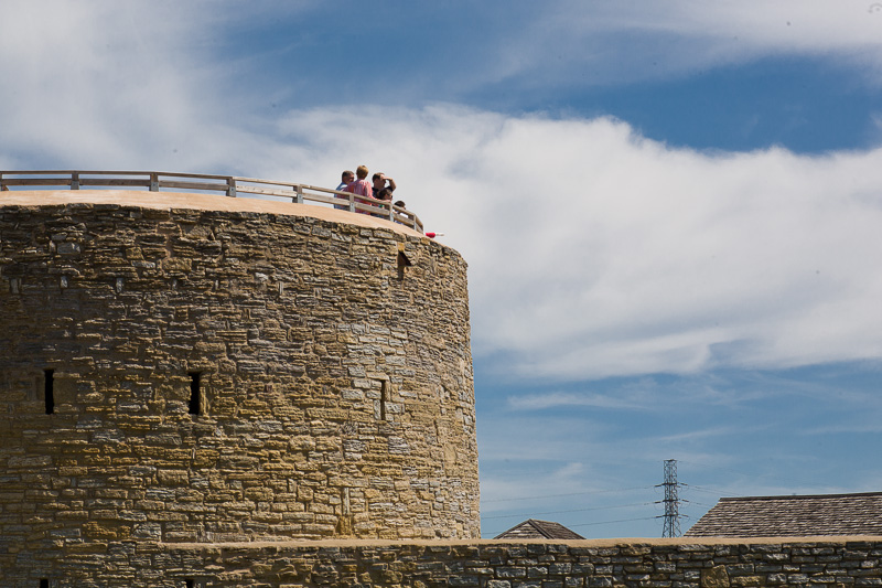 Visitors stand on top of the stone round tower of historic Fort Snelling.