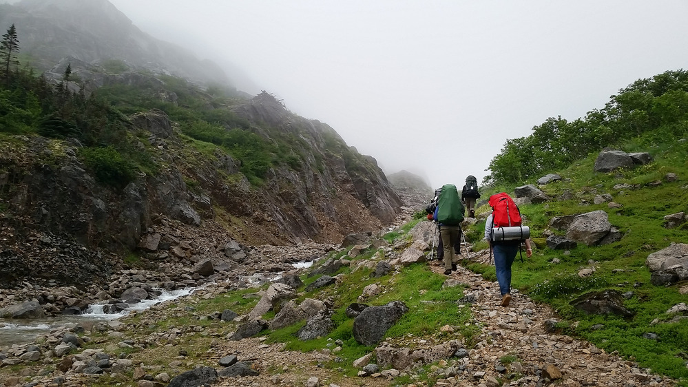 Hikers on a trail with mist