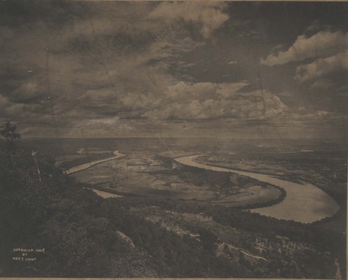 Photographer George Linn maintained a studio on Lookout Mountain, photographing thousands of individuals as they posed on Umbrella Rock. This image looking off the mountain in 1902 shows Moccasin Bend before any land was removed from its toe.