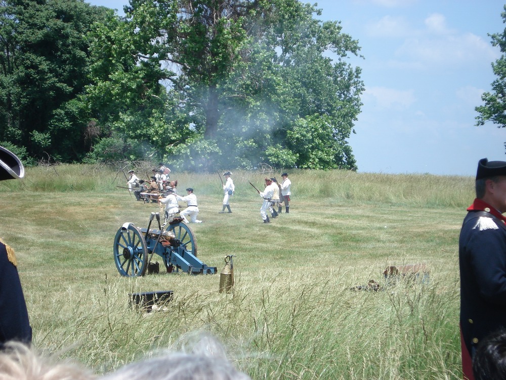 Soldiers participate in musket drill across field for March Out Commemoration.