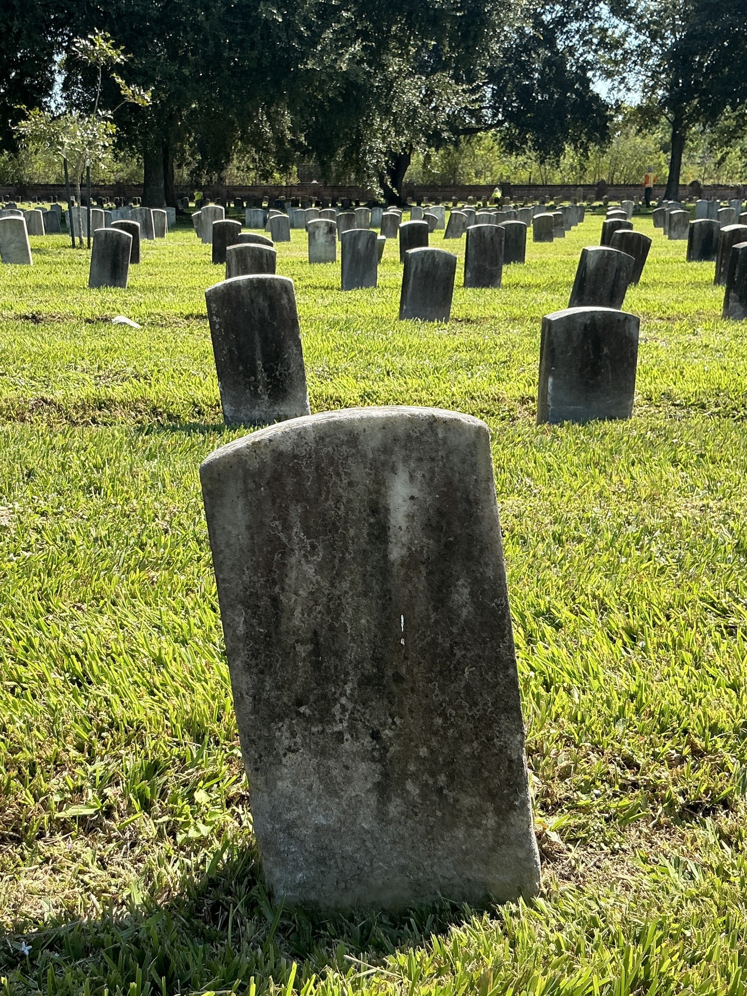 Extra image of historic upright marble headstone with recessed shield with recessed lettering face.