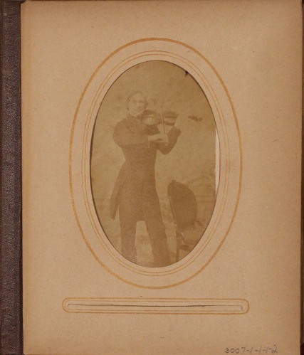 Faded black and white photograph of man playing violin.