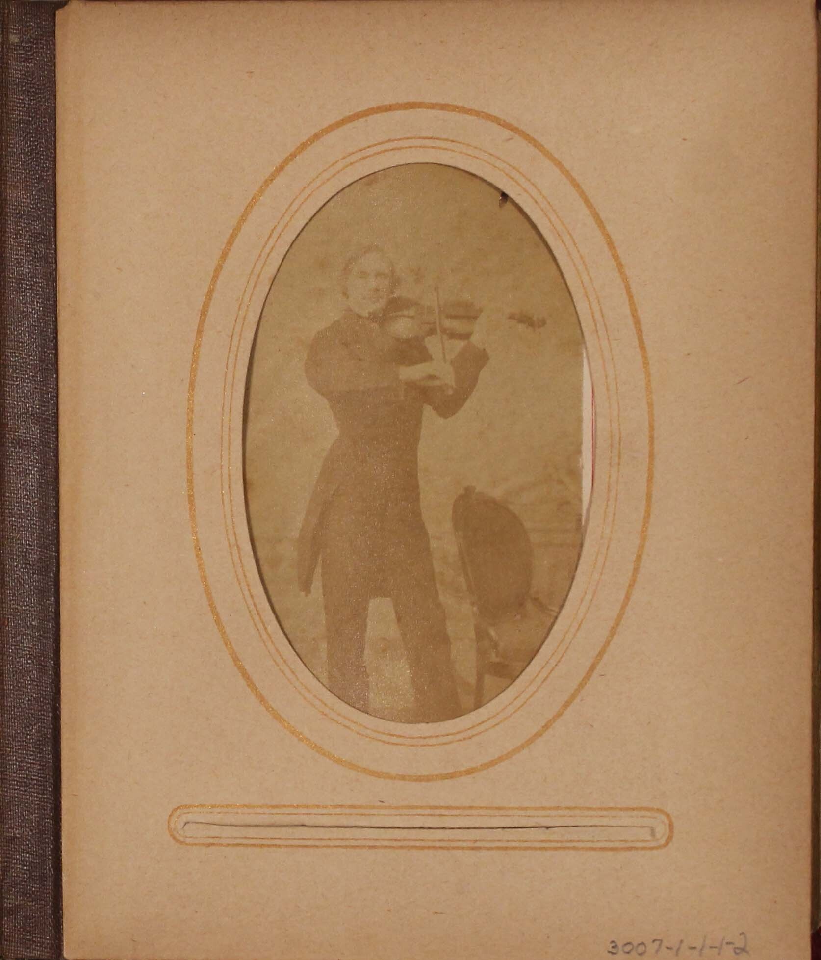 Faded black and white photograph of man playing violin.