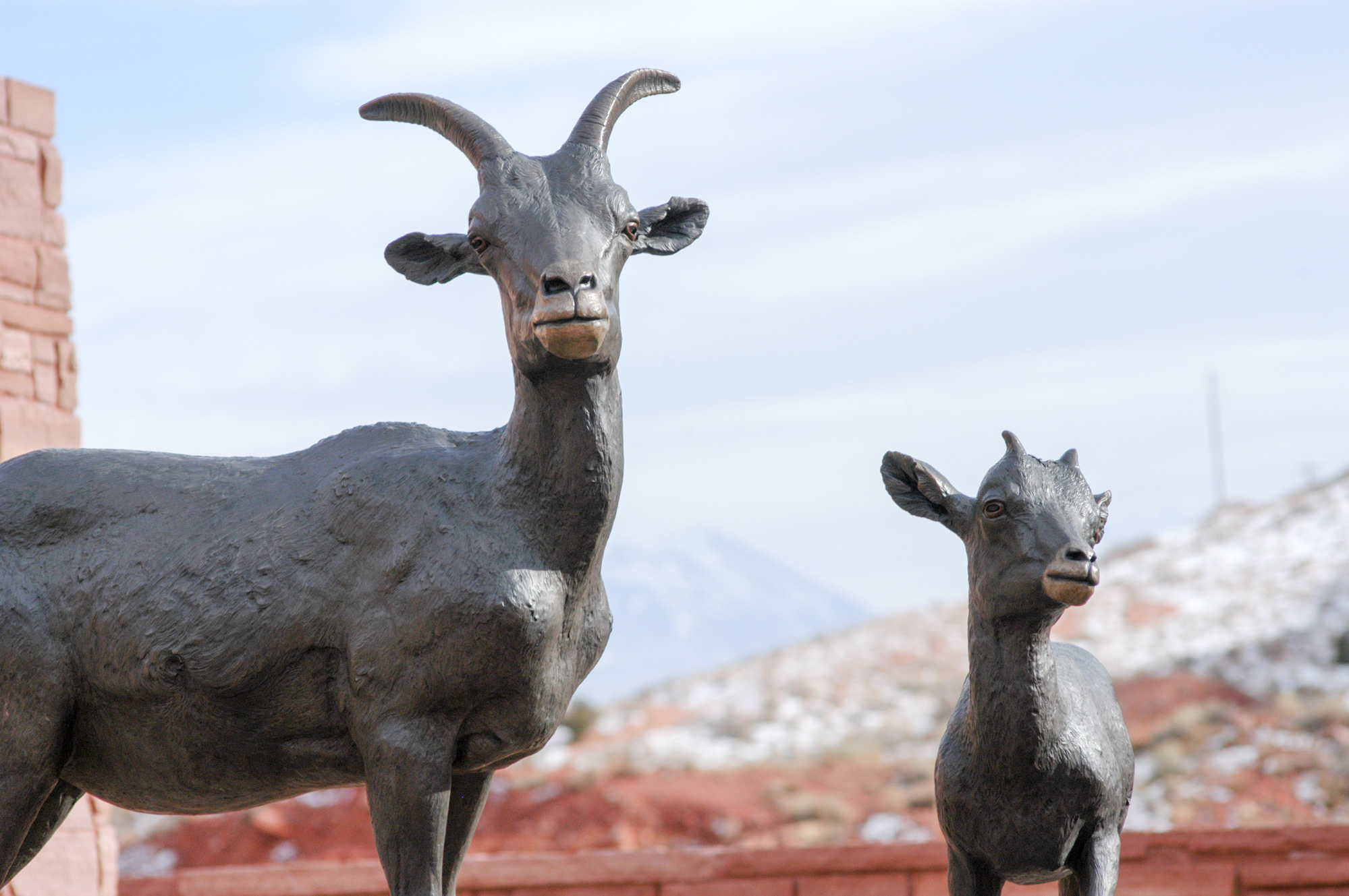 a bronze sculpture of a bighorn sheep ewe and lamb