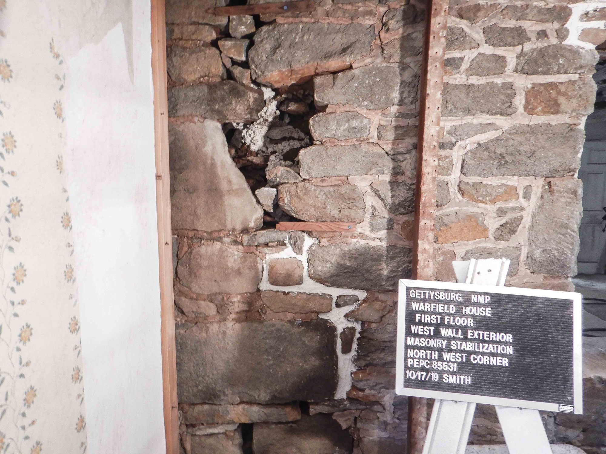  The northwest exterior corner of the first floor, west wall during the masonry stabilization process. The lower portion of the masonry split has been stabilized with mortar infill.