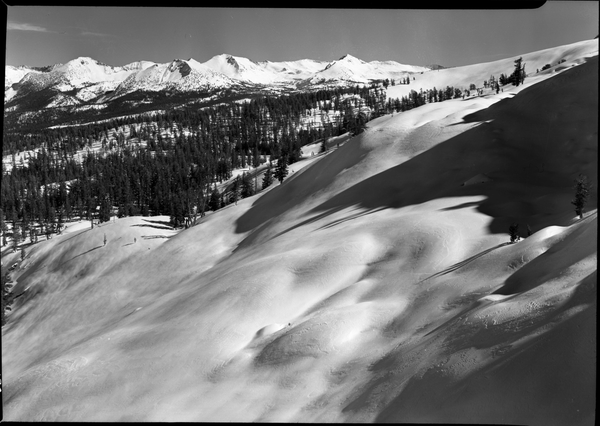 Snow-covered ski slopes from Horse Ridge. [Slopes within easy reach of the Ostrander Lake Ski Hut - Horse Ridge at the right. The spectacular snowcovered Mt. Clark Range in the distance is enticing to skiers for ski tourism. Additional ski huts would be neessary to make such slopes easily accessible.]