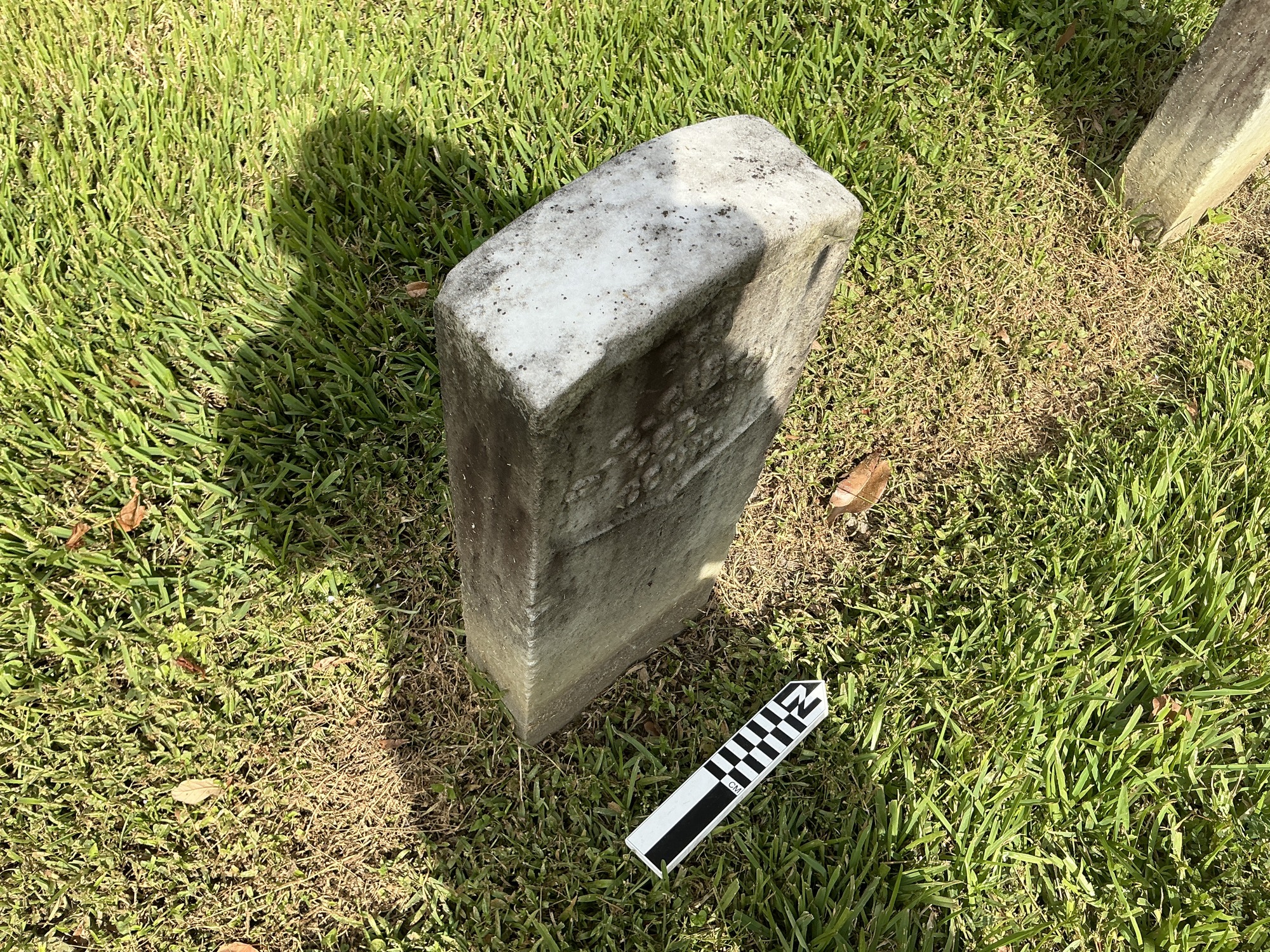 Extra image of historic upright marble headstone with recessed shield face.