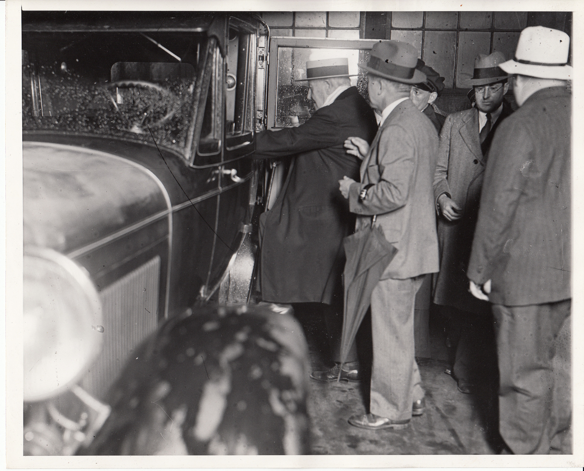 Thomas Edison getting into an automobile.