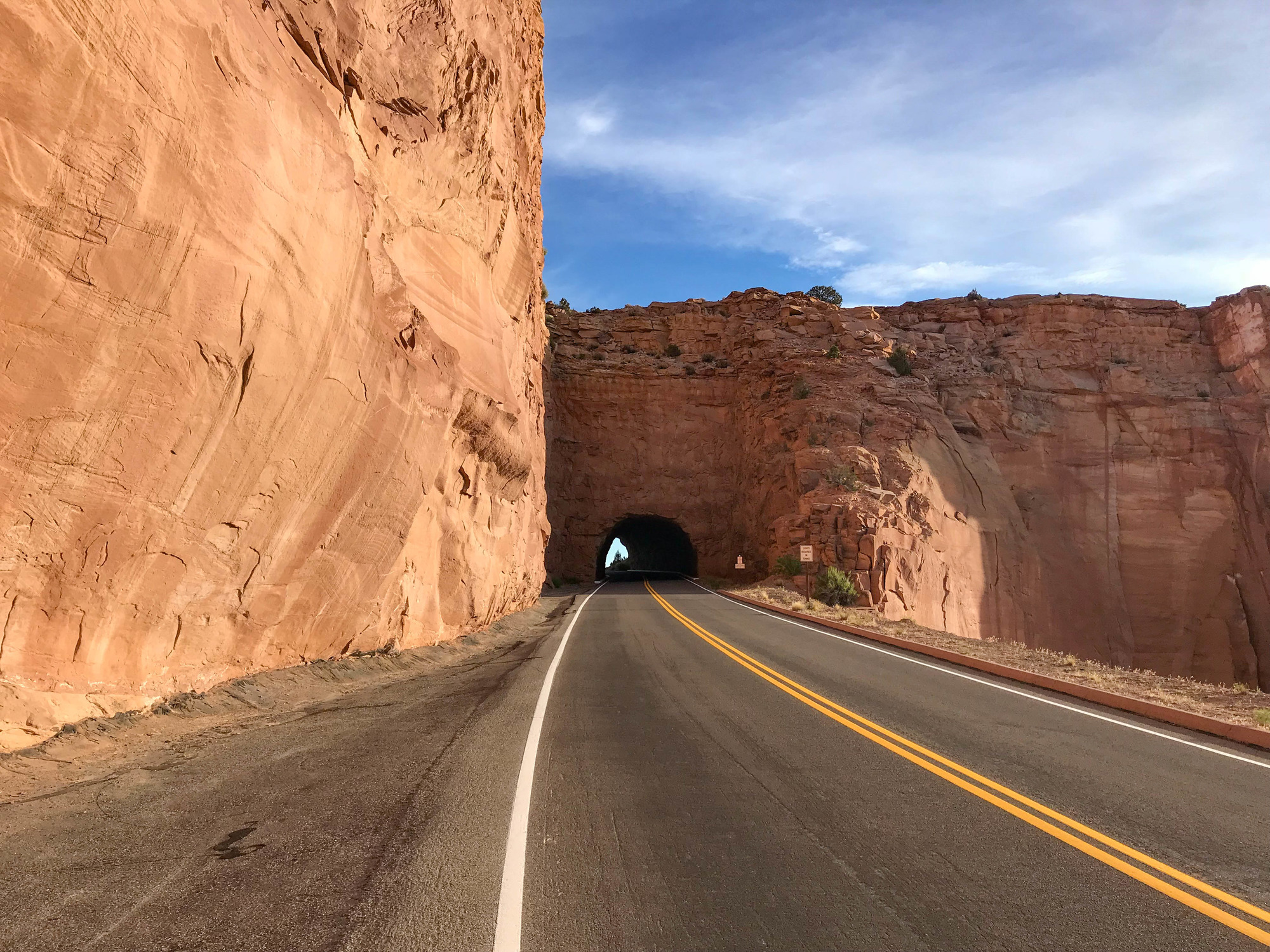 Road leading to a tunnel in a rock wall