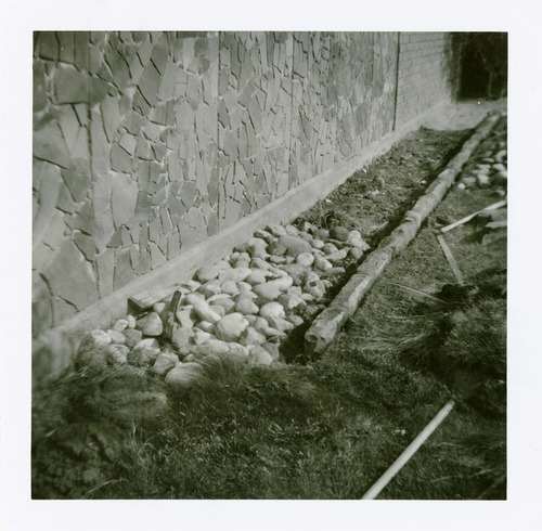 Stone and grass landscaping along the exterior of the old Mission 66 Visitor Center and Museum.