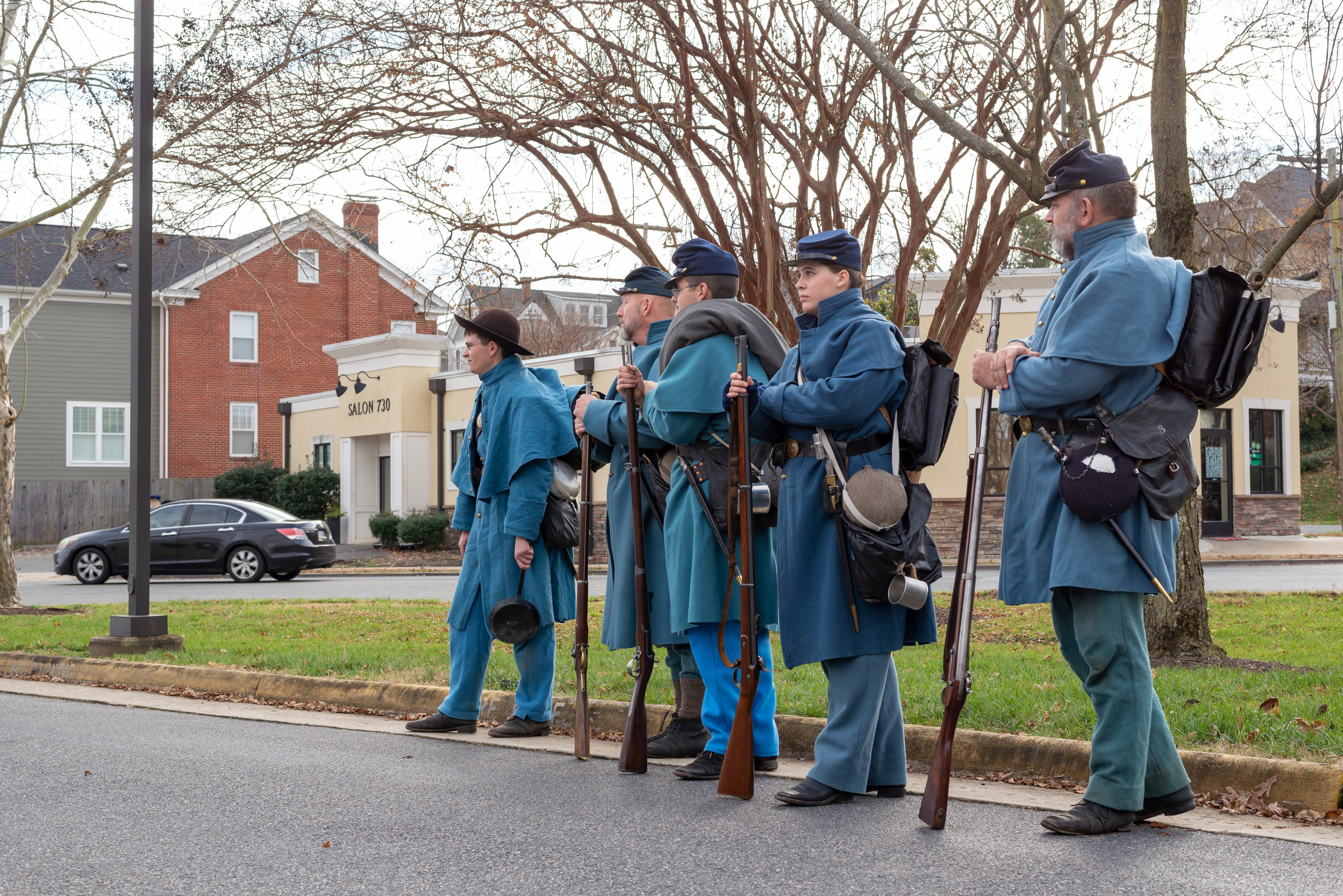 Four Union soldier living historians stand in a line.
