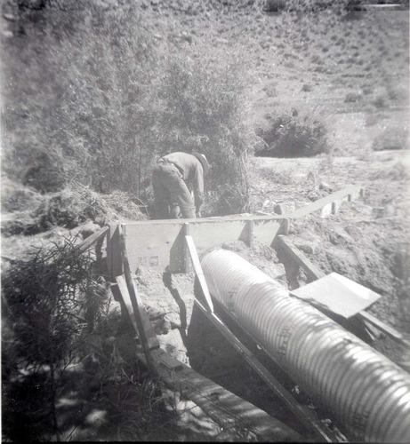 Park personnel installing a culvert/drainage pipe in location in Zion.