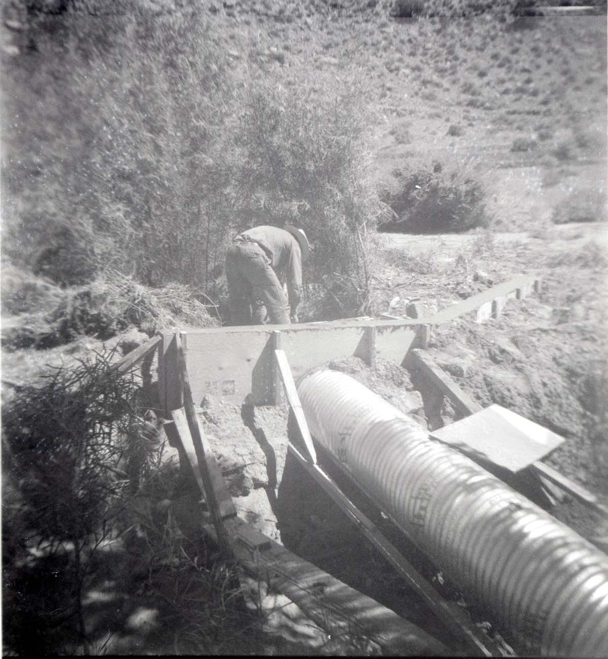 Park personnel installing a culvert/drainage pipe in location in Zion.