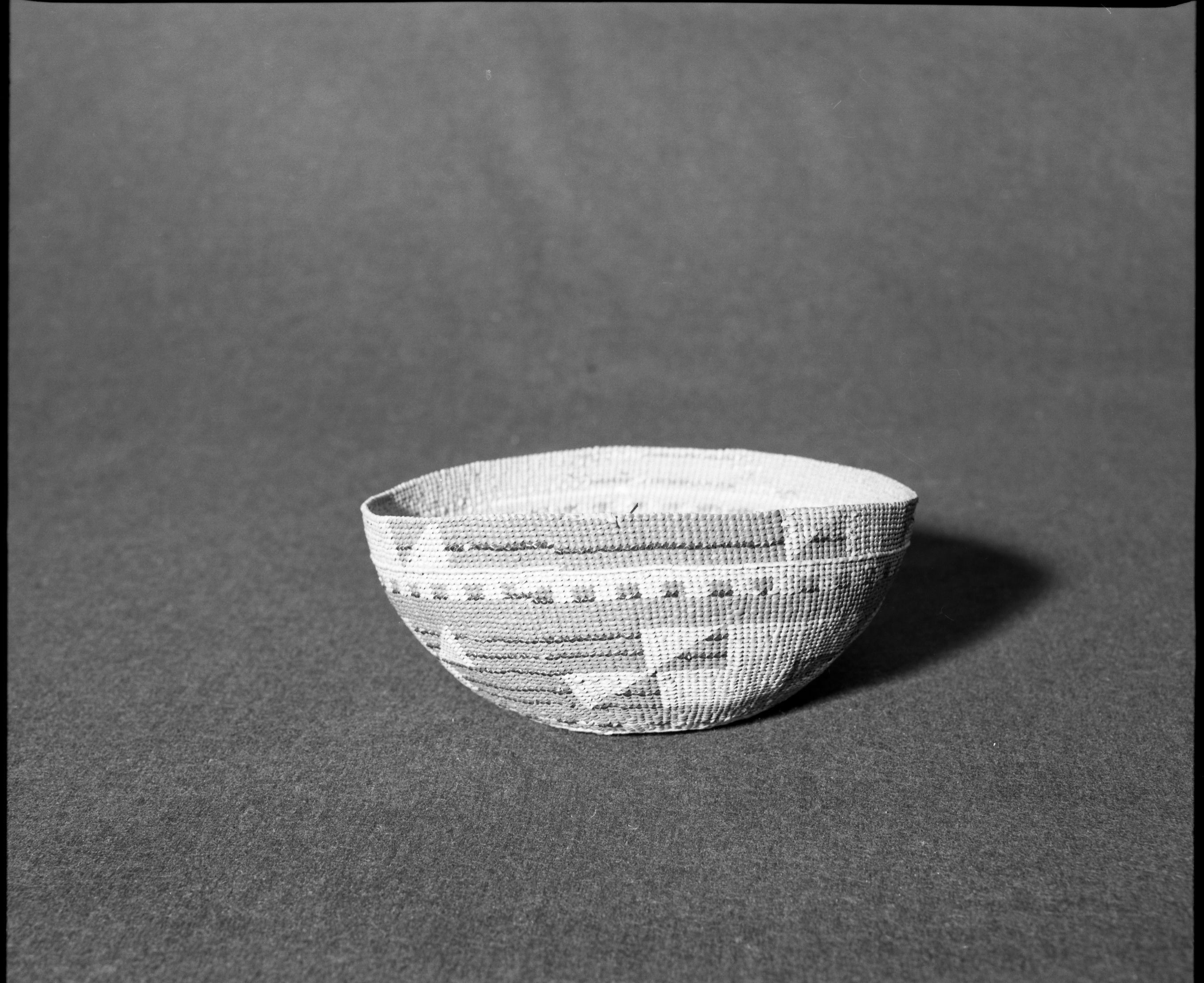 Marie Rozier Collection, Catalog No. 130. Object: Yurok/Karok/Hupa hat. Dimensions: 7 x 3". Materials: Conifer root, maidenhair fern stems, beargrass, woodwardia fern dyed with alder bark. Collection History: Mrs. Long collection, collected between 1890 and 1910. Photographed by Michael Dixon in December 1982. Catalogued by Craig Bates and Barbara Beroza. Yosemite Collections, National Park Service.