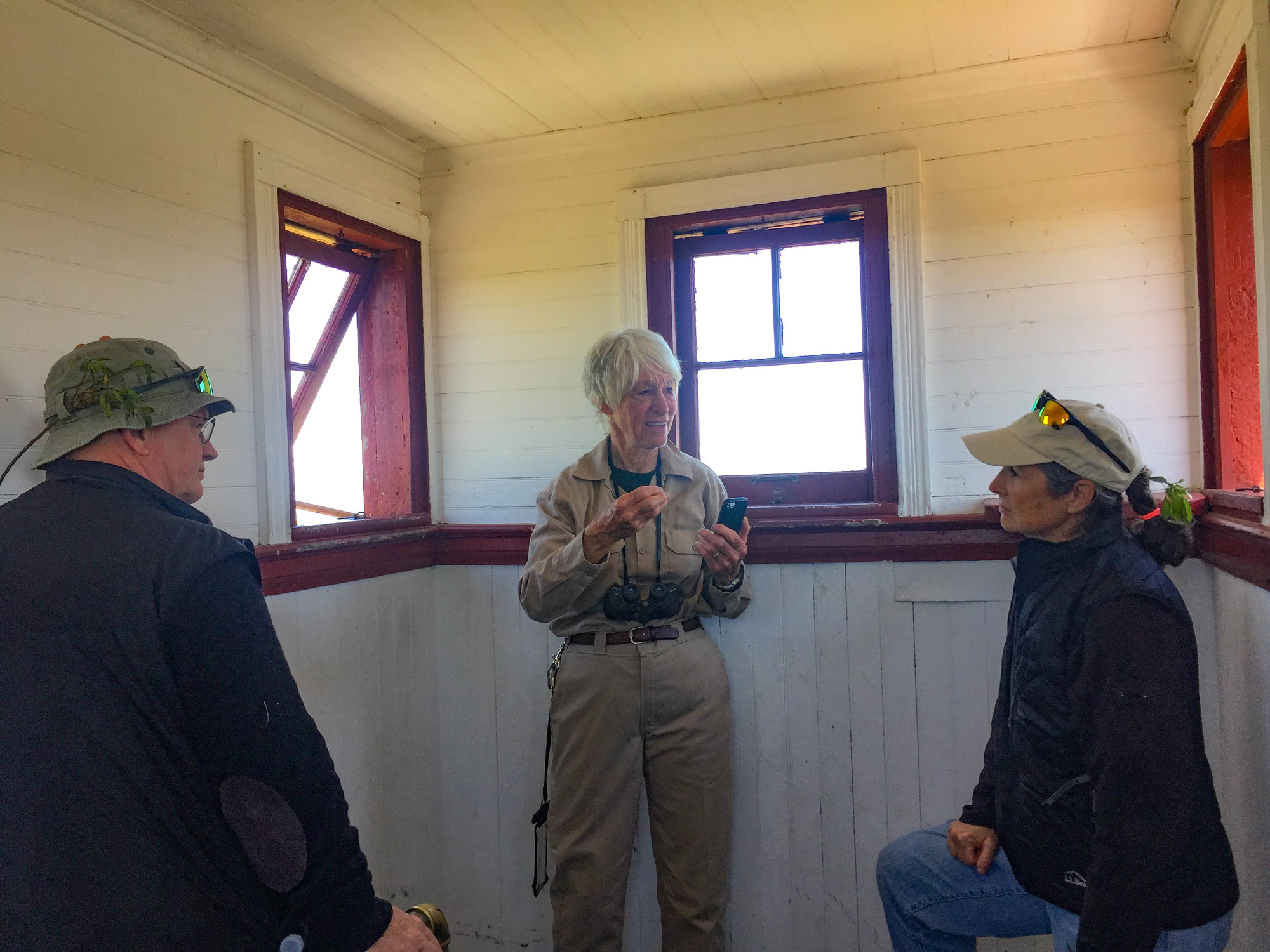 Volunteer talking to visitors in a small room