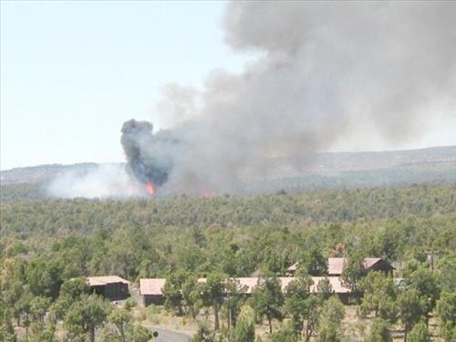 Full fire with black smoke advancing on buildings on the first day of Long Mesa Fire, Mesa Verde National Park, July 29, 2002