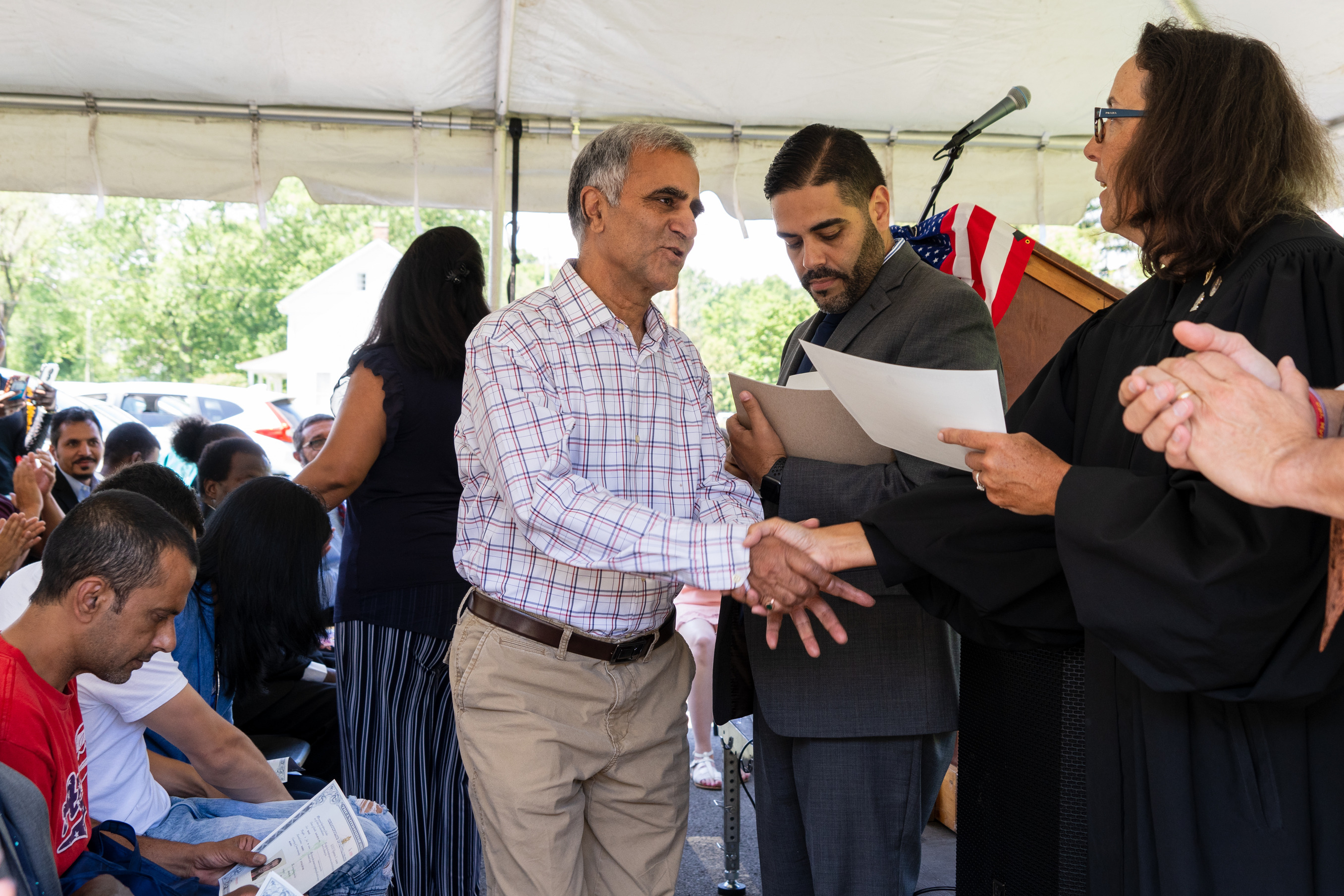 A man receives a certificate and a hand shake.