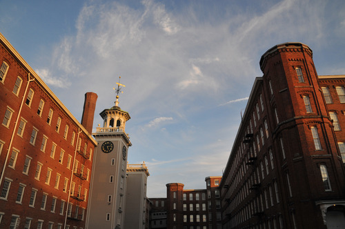 A mill building and its tower in front of a skyline. 