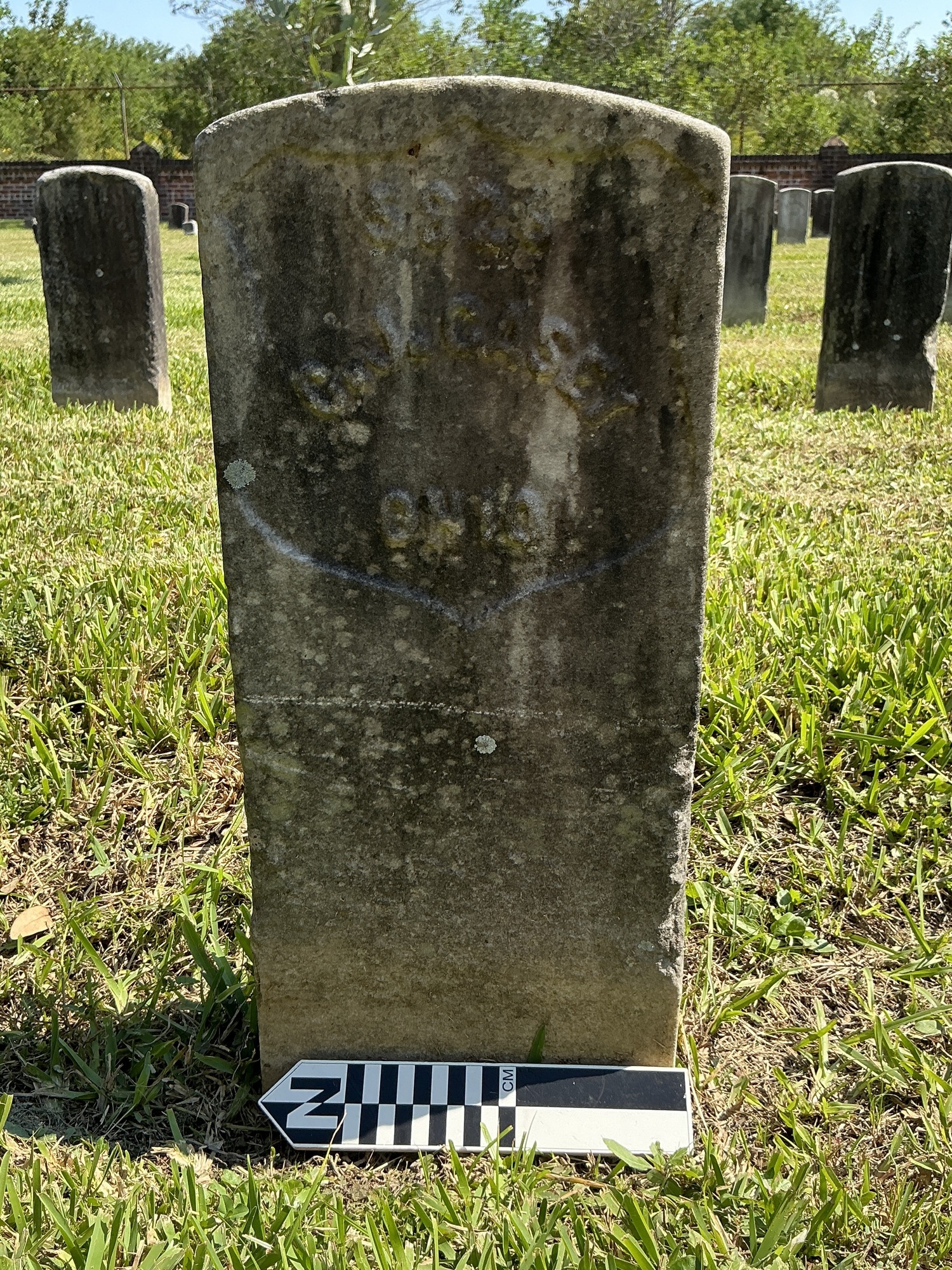 Extra image of historic upright marble headstone with recessed shield face.
