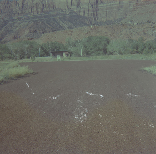 Road leading to building and parking area during chipsealing of Zion roads.