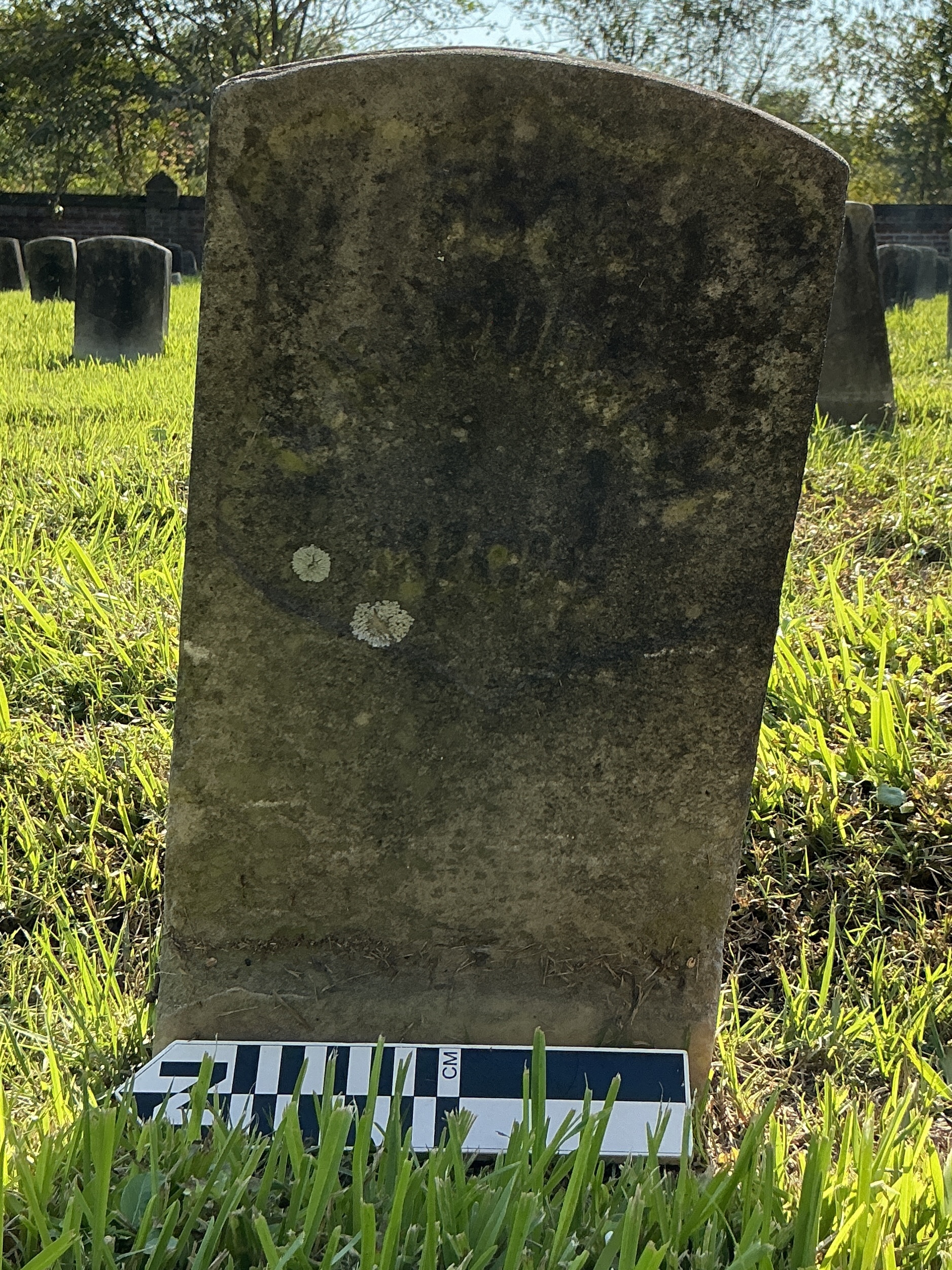 Extra image of historic upright marble headstone with recessed shield face.