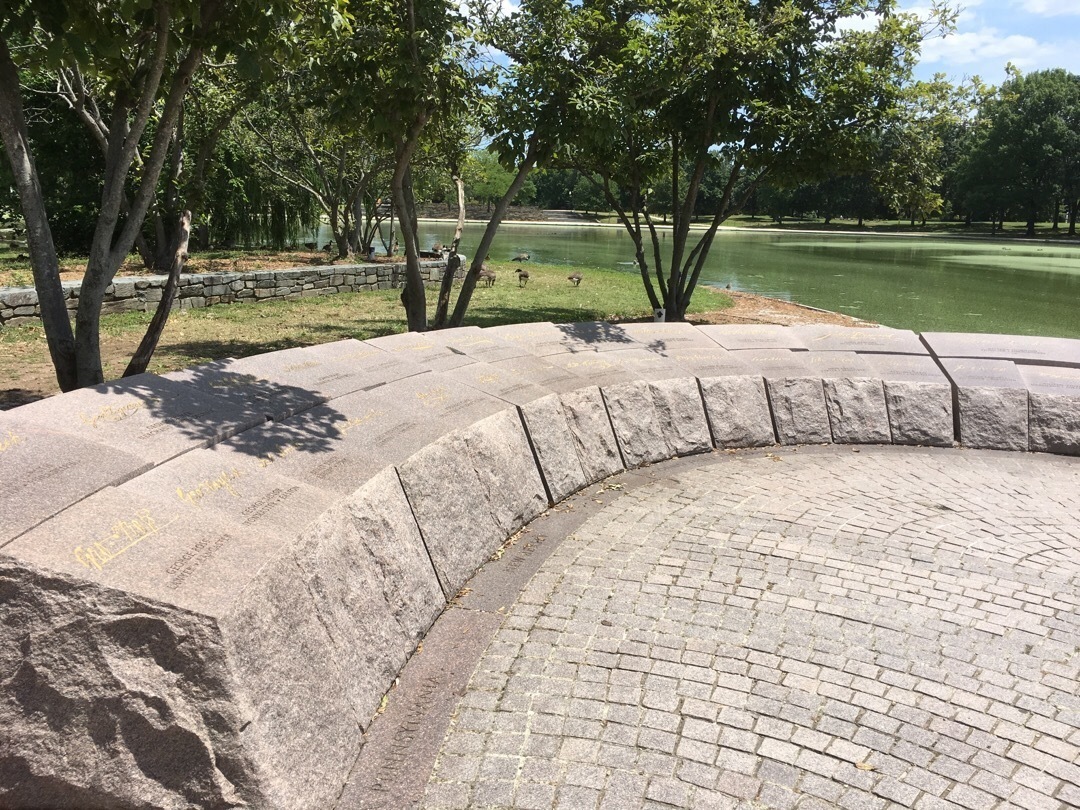 A short circular stone memorial lists the names of the signers of the Declaration of Independence