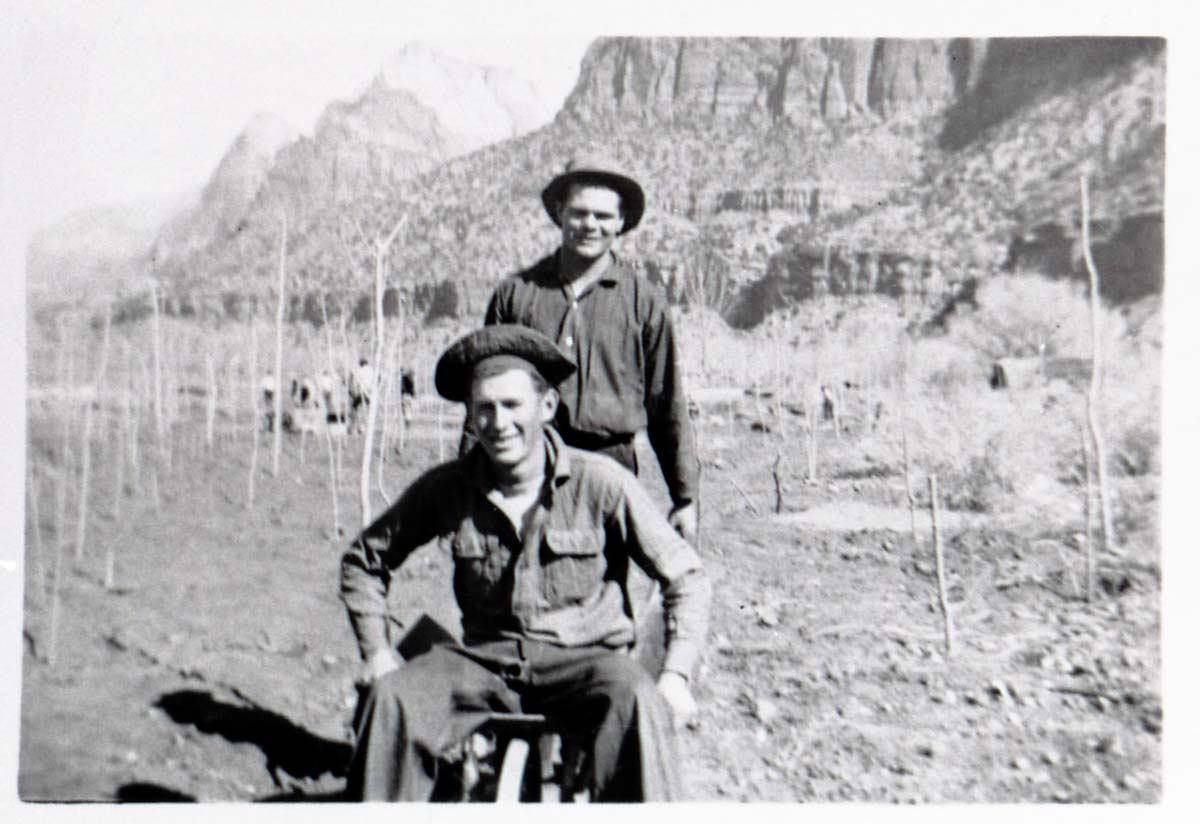 Two Civilian Conservation Corps (CCC) men riding in wheel barrow near the South Entrance.