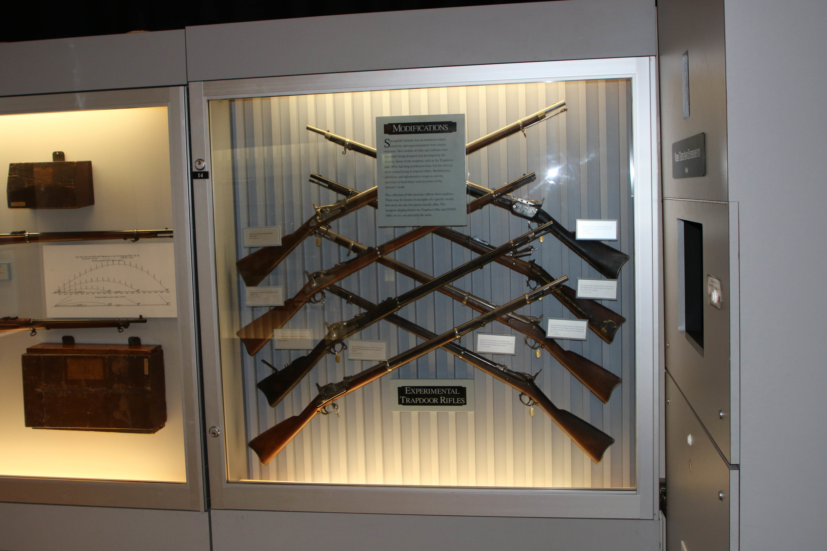 Museum exhibit including crisscrossing rifles 