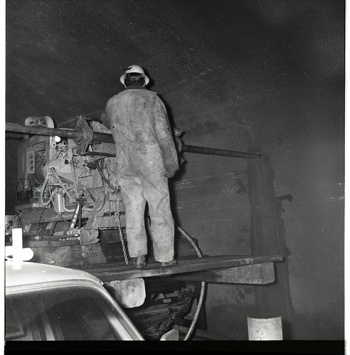 Worker works with drill rig during test hole drilling in Zion-Mt. Carmel tunnel.
