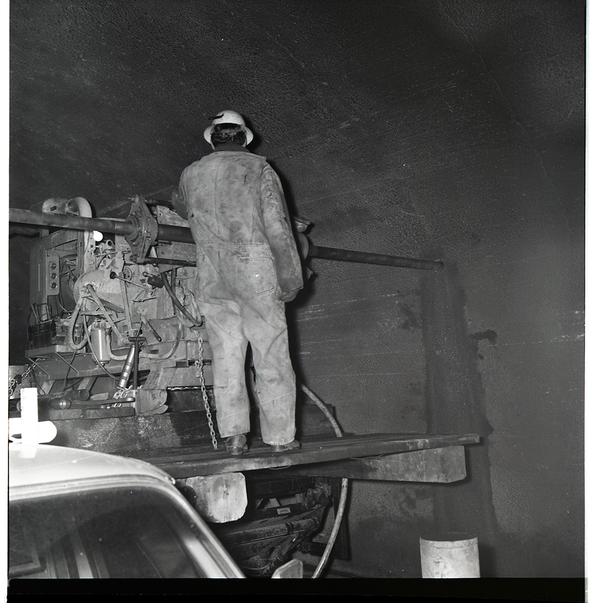 Worker works with drill rig during test hole drilling in Zion-Mt. Carmel tunnel.