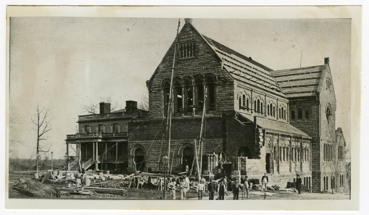 Black and white photo of Hamilton Grange standing next to a newly erected St. Luke's Church, with the church undergoing construction.