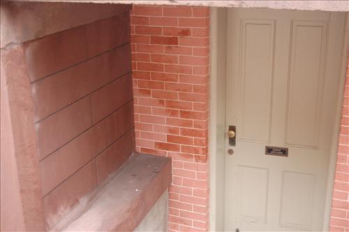 Water infiltration and damage to walls and floor of the Petersen House