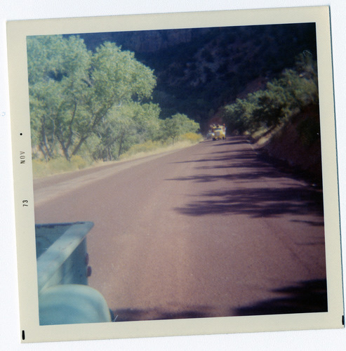 Construction vehicles driving along road during road repairs.