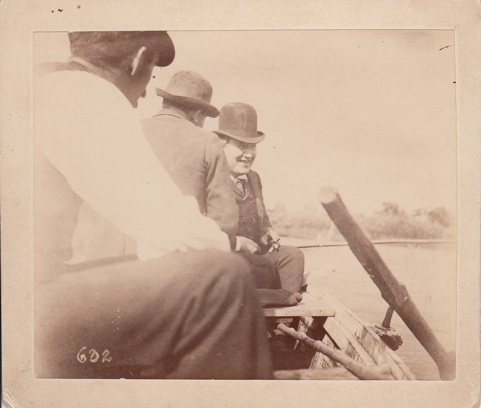 Unidentified man, Fred Ott, and Thomas Edison in row boat.