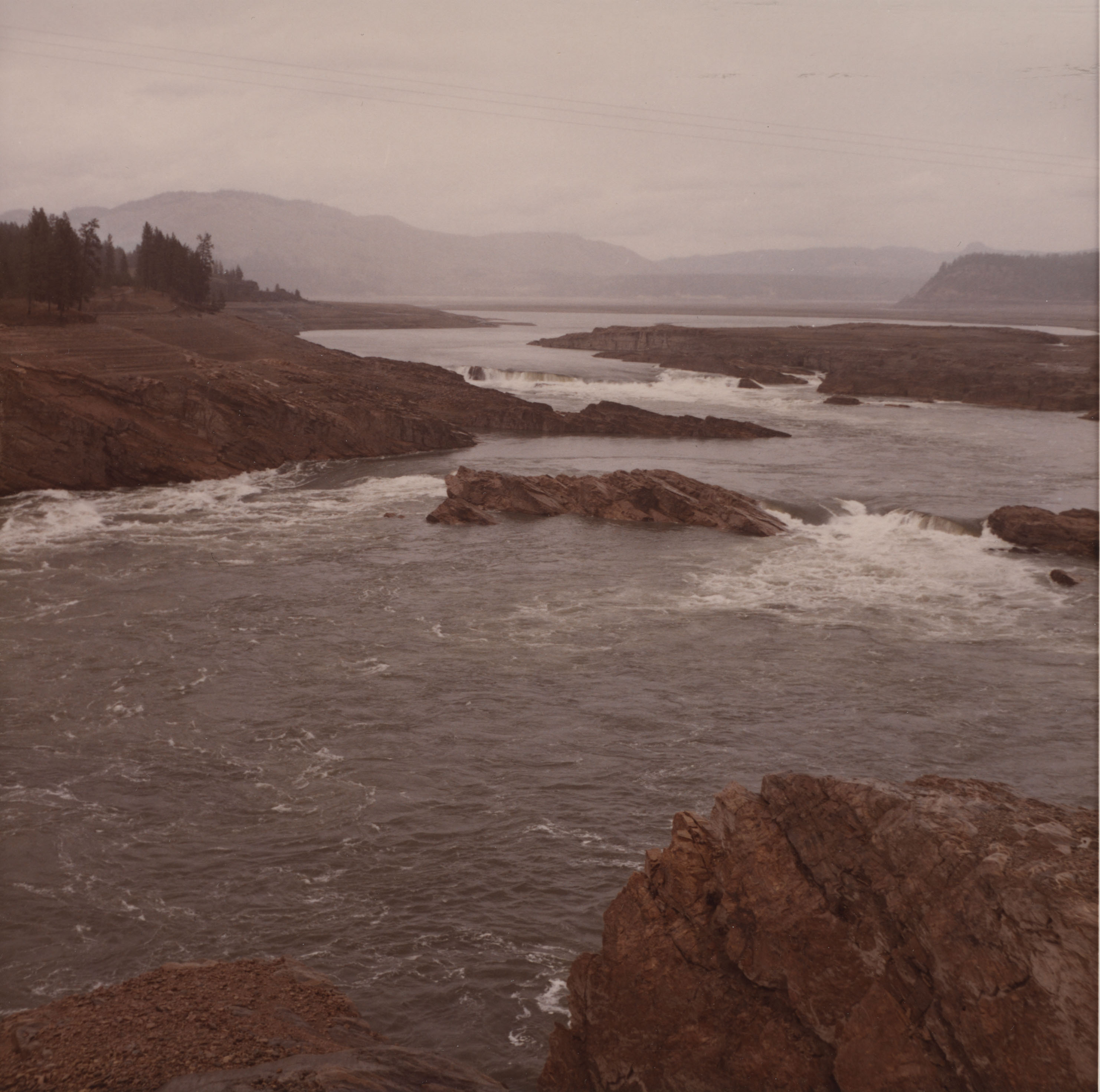 Color photograph of a river in a valley of exposed rock