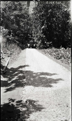 Narrows Trail construction- rolling on the locking course with a caterpillar tractor pulling the roller.